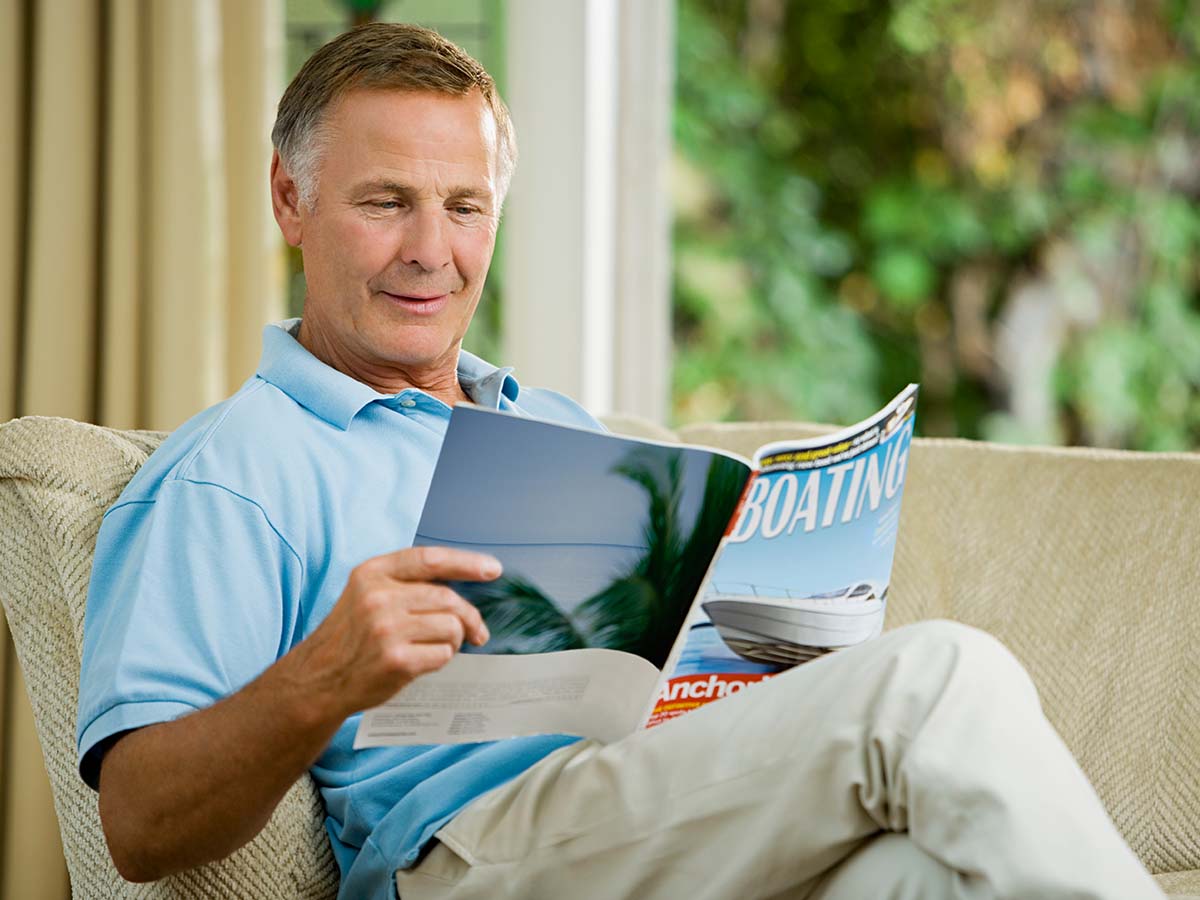 man reading magazine