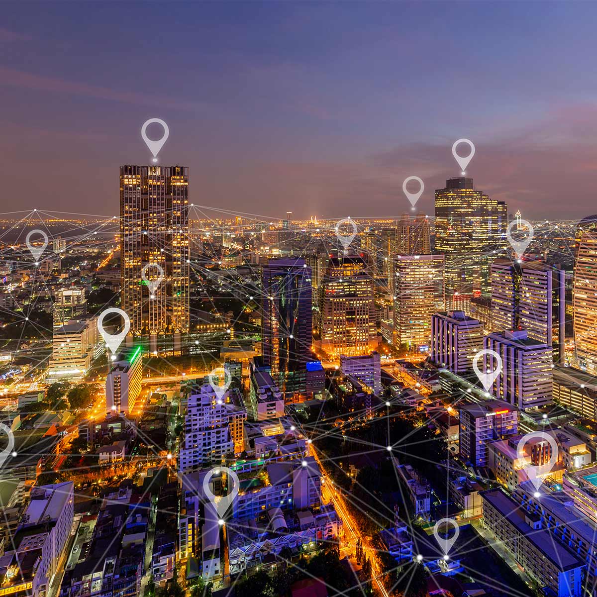 Night skyline of metropolitan city with network of connected pushpins identifying various buildings