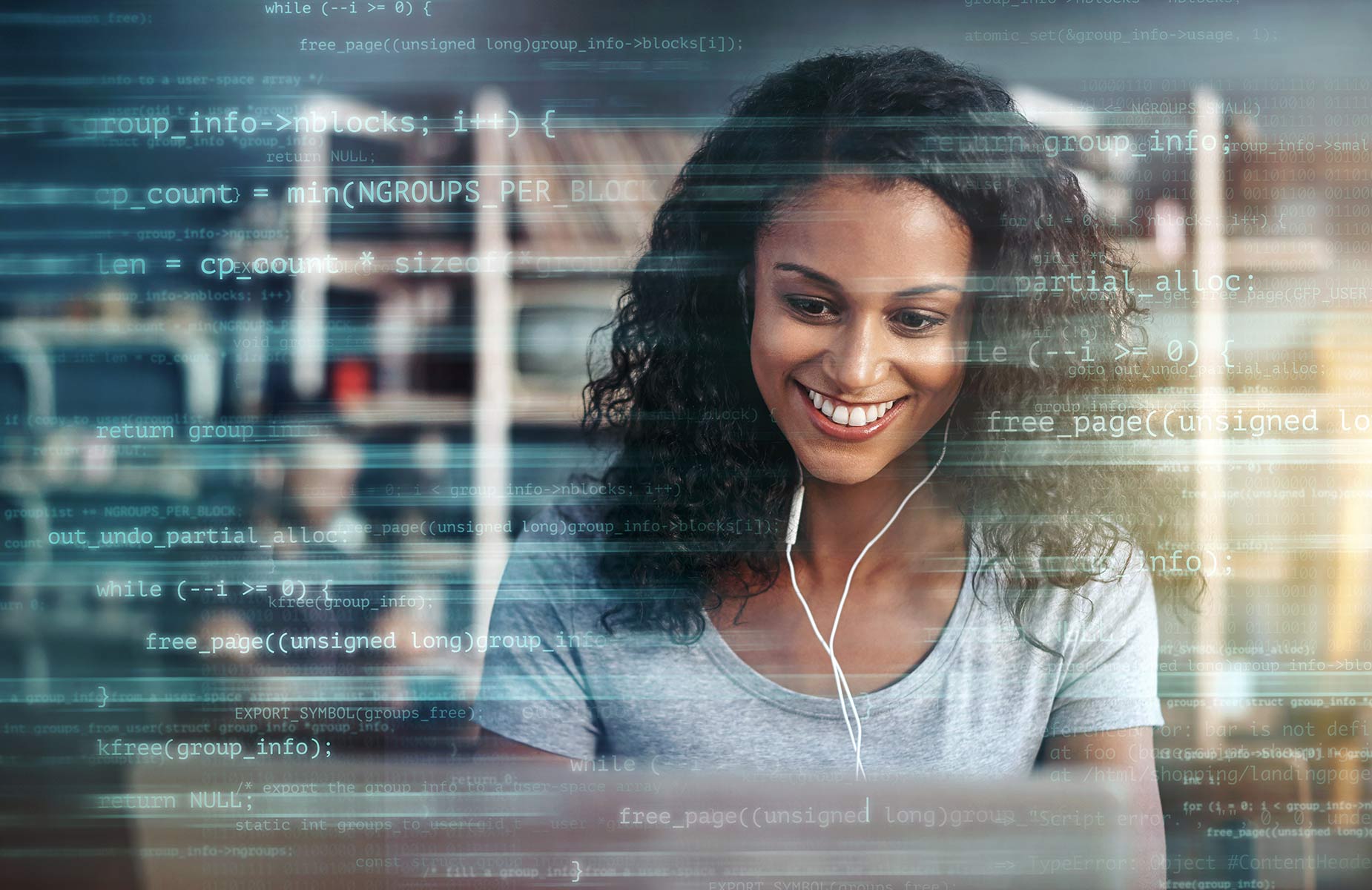 Smiling woman working at laptop in office setting