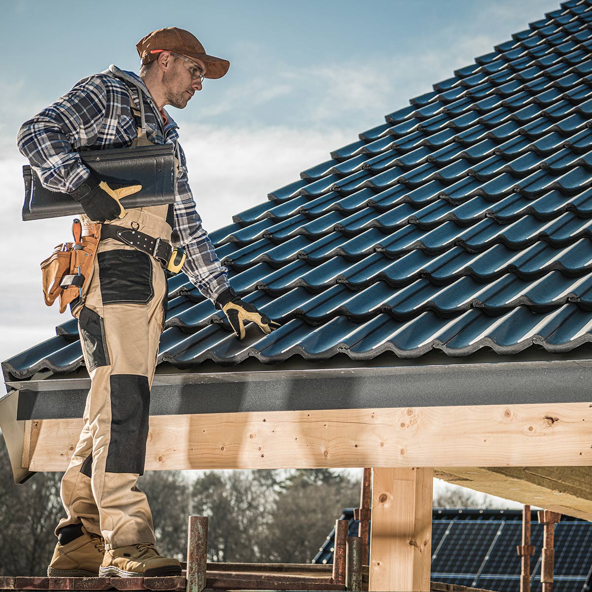 Roof installer inspecting roof